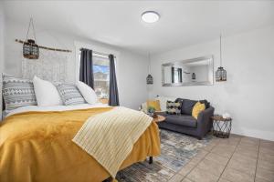 a bedroom with a bed and a couch at Unit 5: Sun drenched studio with tranquil vibes in Billings