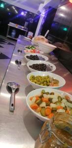 a buffet line with bowls of food on a table at فندق كلاسيك in Aqaba