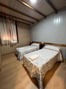 two beds in a room with wooden floors at Alojamiento Cerro de las Salinas in Ronda +18 photos