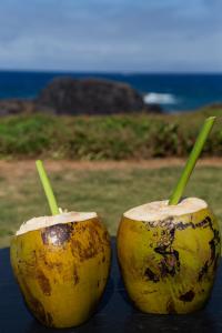 two halves of a yellow coconut with green stems at Pousada Santu Noronha in Fernando de Noronha