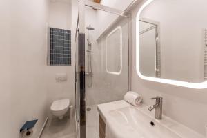 a bathroom with a shower and a sink and a mirror at Studio proche cité internationale in Caluire-et-Cuire