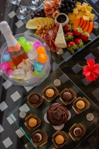 a table with a buffet of food and desserts at Pousada Santu Noronha in Fernando de Noronha