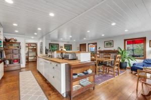 a kitchen and living room with a couch and a table at Seabeck House & Cottage on Hood Canal in Seabeck