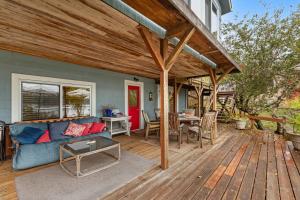 a patio with a blue couch and a table at Seabeck House & Cottage on Hood Canal in Seabeck