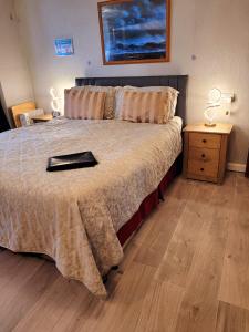 a bedroom with a bed with a tray on it at Kilbrannan Guest House in Great Yarmouth