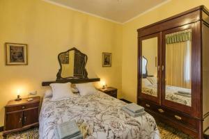 a bedroom with a large bed and a large mirror at Can Mateuet - House Rental by Season in Llagostera