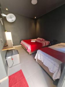 a bedroom with two beds and a red blanket at Pousada D'san in Vinhedo +28 photos