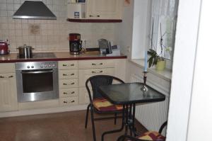 a small kitchen with a table and a stove at Ferienhaus Erika in Geringswalde