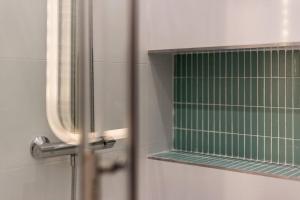 a glass door with a green window in a bathroom at Grand T2 avec balcon • proche parc de la Tête d'Or in Caluire-et-Cuire +11 photos