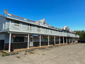 a large building with a balcony on top of it at Hotel Carmacks in Carmacks