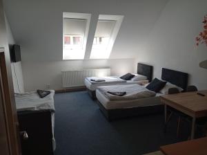 Postel nebo postele na pokoji v ubytování Penzion Pralinka