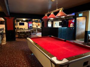 a pool table in a room with a bar at Hotel Carmacks in Carmacks
