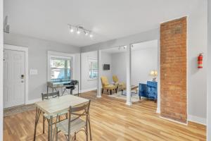 a living room with a table and chairs and a brick wall at Charming Cleveland Haven Duplex in Cleveland