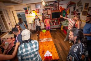 a group of people standing in a living room at Books Hostel in Rio de Janeiro +67 photos