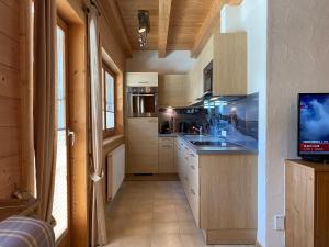 a kitchen with a sink and a counter top at Alpenchalets Waldheim in Finkenberg