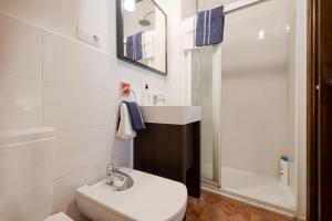 a white bathroom with a sink and a toilet at Central, near the Alhambra, quiet and autentic! in Granada +16 photos
