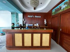 a bathroom with a large wooden counter with a sink at Abby's House Hotel in Patong Beach