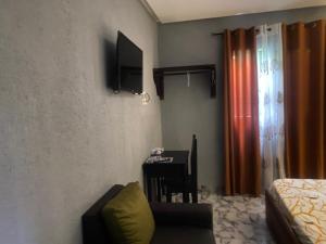 a room with a table and a chair and a desk at Sunrise Center Bonapriso 104 in Douala