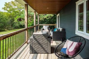 a porch with a couch and chairs on a deck at Grays Lane - Minutes to Sandbanks in Bloomfield
