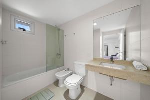 a white bathroom with a toilet and a sink at La Vie Suite Barrio Norte in Buenos Aires +49 photos