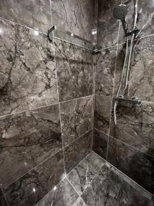 a bathroom with a marble shower with a shower at Liepājā 4:10 pm in Liepāja +24 photos