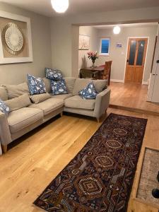 a living room with a couch and a rug at Cosy beach house steps from the sea in Cromer