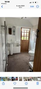 a bathroom with a toilet and a sink at Kings head Inn 