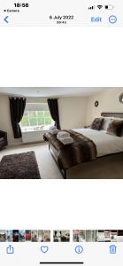 a bedroom with a large bed and a window at Kings head Inn 