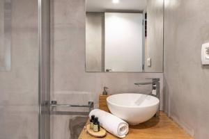 a bathroom with a white sink and a mirror at Arrantzale Etxea in Getxo