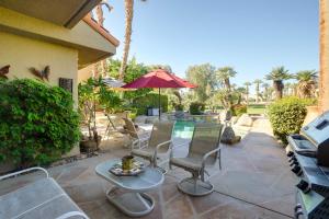 a patio with a table and chairs and an umbrella at Rancho Mirage Retreat Pool, Spa and Fireplace! in Rancho Mirage