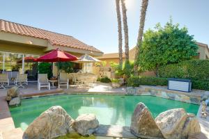 a swimming pool with rocks in a yard at Rancho Mirage Retreat Pool, Spa and Fireplace! in Rancho Mirage