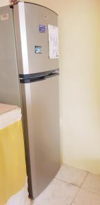 a refrigerator in a kitchen with a wall at "SunRise Inn" Nature Island Dominica 