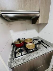 two pots and pans on a stove in a kitchen at Apartamento vista al mar in Iquique