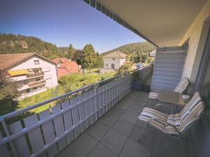 a balcony with chairs and a view of the mountains at Hotel Sonnenhof Garni in Bad Herrenalb