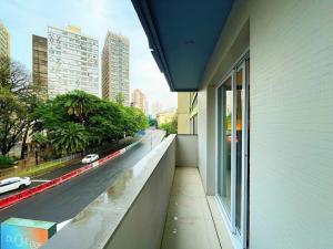 a balcony of a building with a view of a street at Studio Duque Classic in Porto Alegre