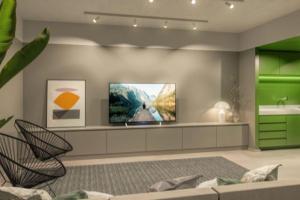 a living room with a flat screen tv on the wall at Studio Duque Classic in Porto Alegre