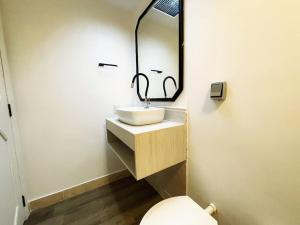 a bathroom with a sink and a toilet at Studio Duque Classic in Porto Alegre