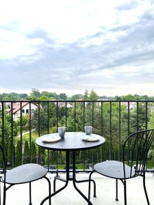 a table and chairs on a balcony with a view at Zarembowicza 31 Apartment - Self Check-In 20h - Lift in Wrocław