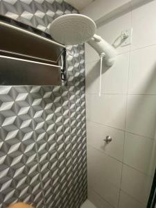 a bathroom with a shower with a light on the wall at Lindo apartamento no centro de Belém in Belém