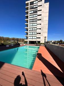 a shadow of a person taking a picture of a building at Apartamento frente al lago in Montevideo