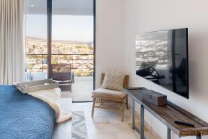 a room with a bed and a desk and a window at Montemar D 502 in Cabo San Lucas