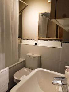 a bathroom with a toilet and a sink and a tub at Little Paradise in Marlborough in Marlborough