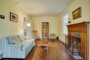 a living room with a couch and a fireplace at Historic Home in Taylors Falls with Patio and Fire Pit in Taylors Falls