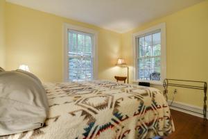 a bedroom with a bed and two windows at Historic Home in Taylors Falls with Patio and Fire Pit in Taylors Falls