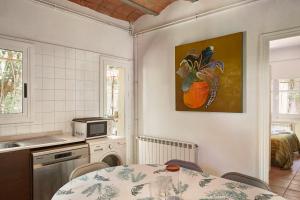 a kitchen with a table and a painting on the wall at Casa Belladona Barcelona in Barcelona