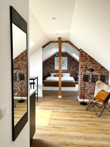 a bedroom with a bed in a brick wall at Schickes Studio in bester Lage in Bad Salzuflen