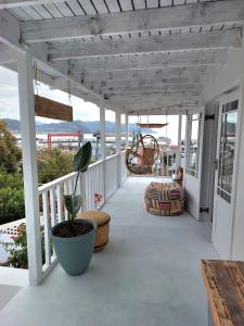 a white porch with a potted plant on it at House On The Hill in Cape Town