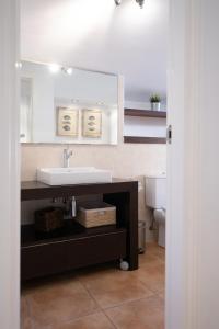 a bathroom with a sink and a mirror at Jávea terraza + piscina + vistas al mar in Platja de l'Arenal