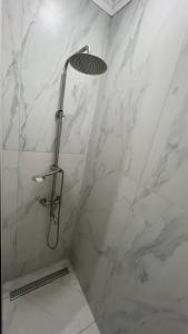 a shower with a glass door in a bathroom at Батыс in Aktobe