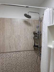 a shower in a bathroom with a shower curtain at Lux Apartment Vivo Mall in Baia Mare
